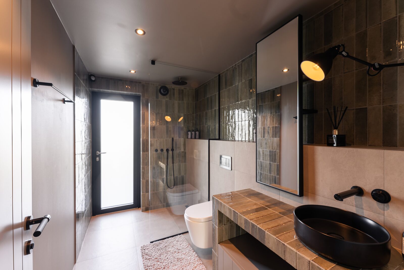 The separate WC seen from the hallway, with its round black basin visible.