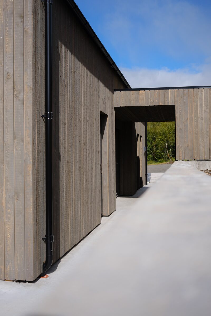 Dark vertical larch cladding on the exterior of the house at Lundskógur.