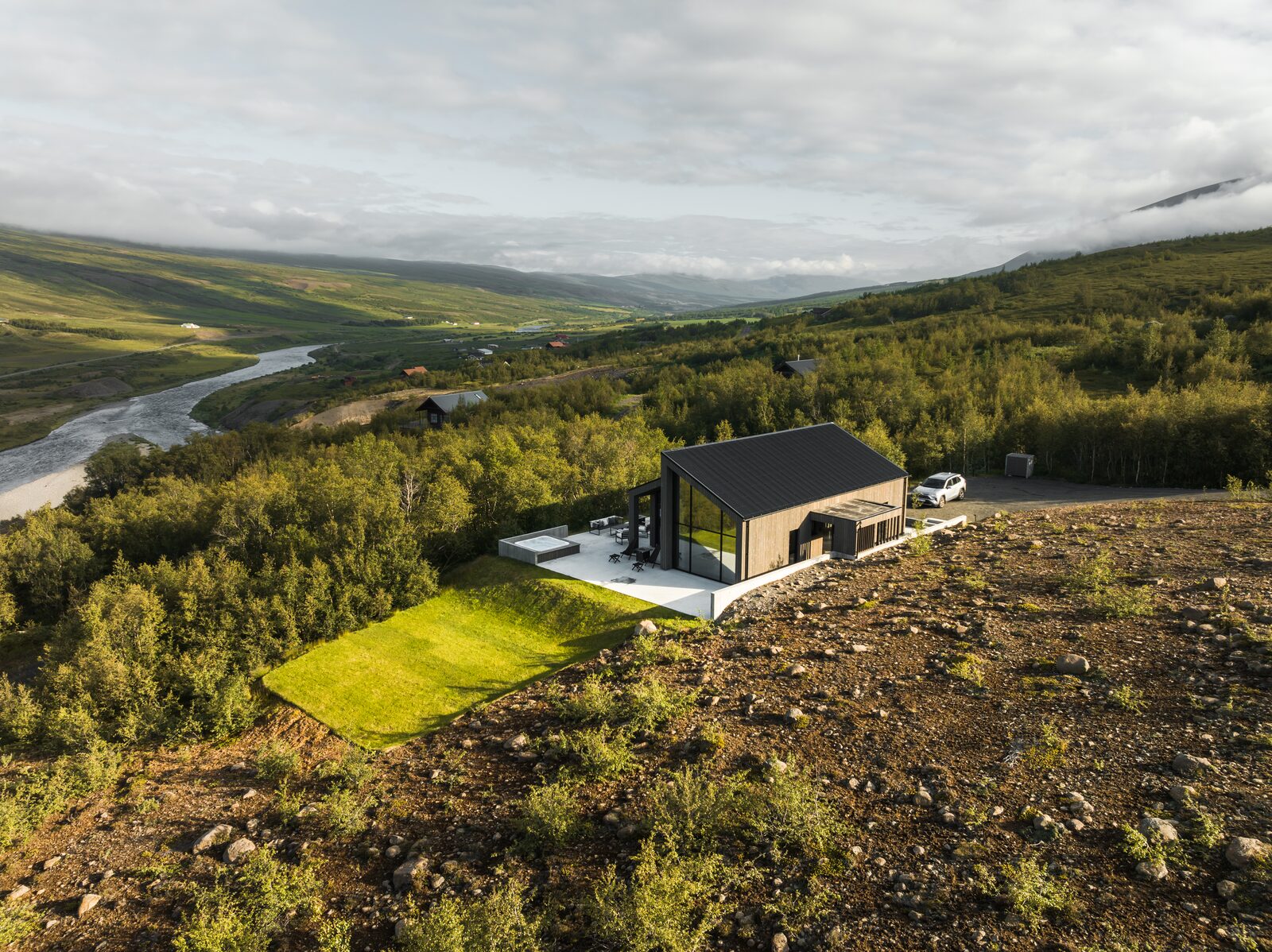 An aerial view of the house at Lundskógur in Fnjóskadalur, with the Fnjóská river winding through the valley.