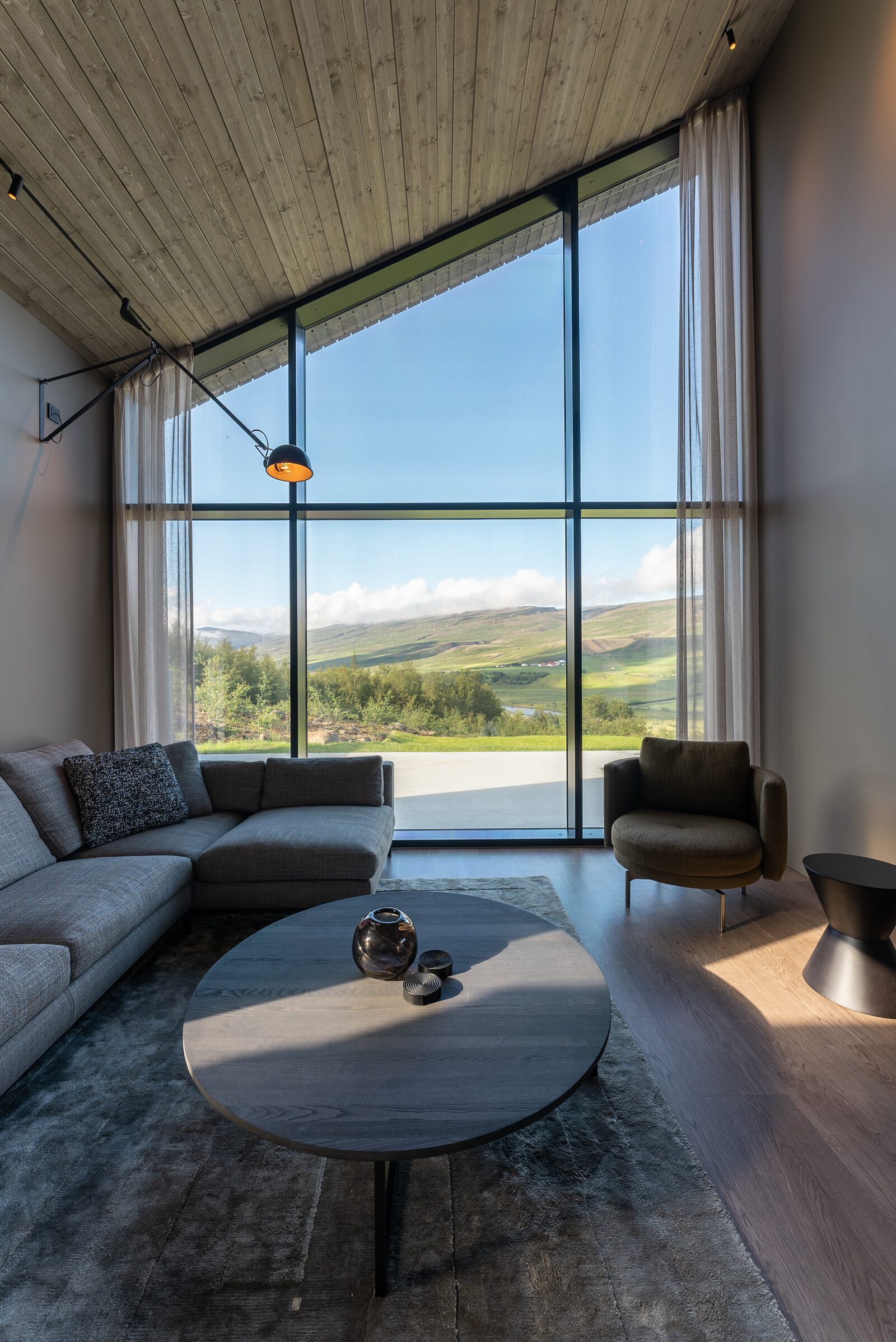 The living area at Lundskógur, with a sofa and armchairs gathered around the coffee table.