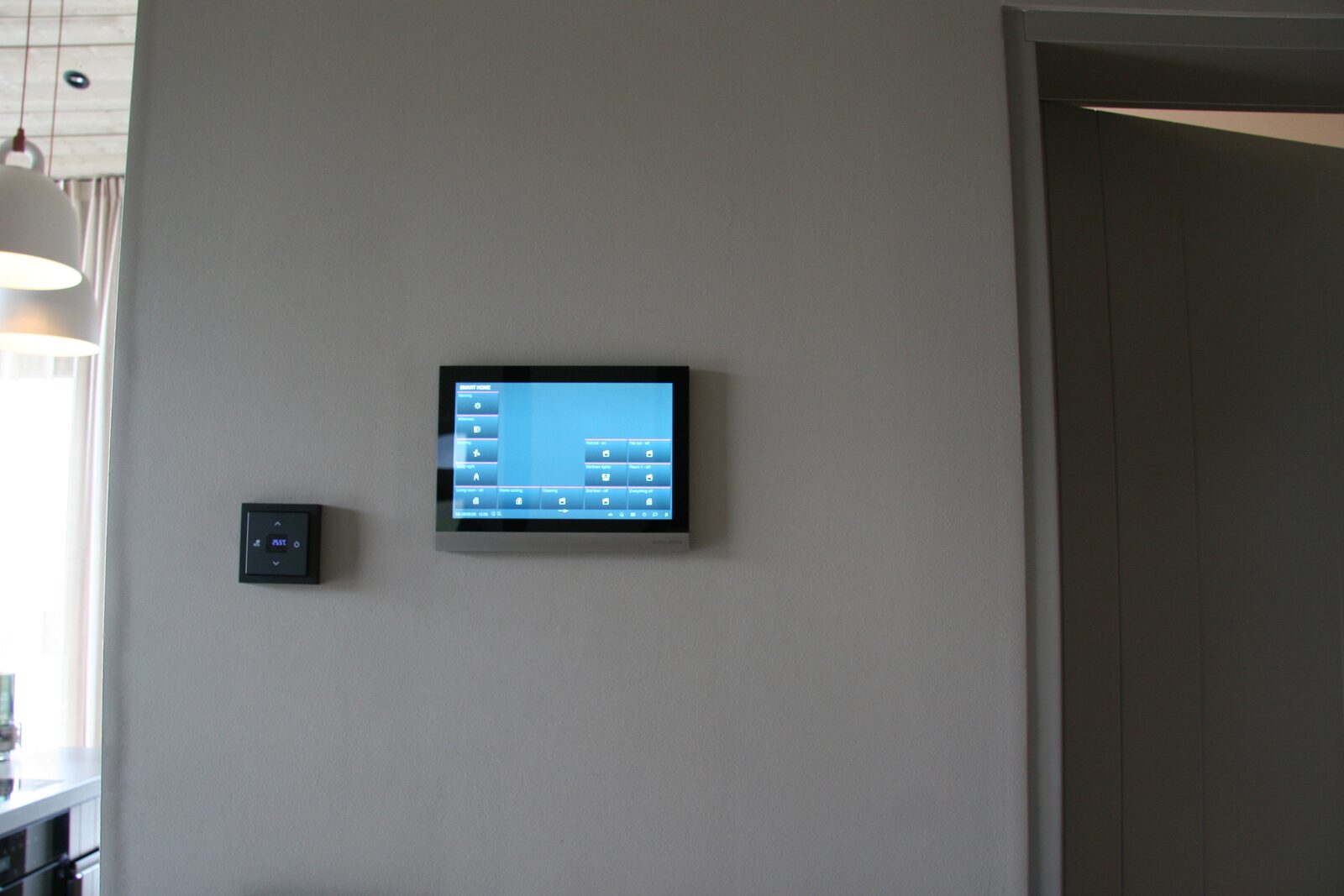 The wall-mounted touchscreen used to control lighting and temperature.